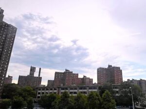Bernard M. Baruch Houses towers under cloudy sky behind a NYCHA community facility in Manhattan