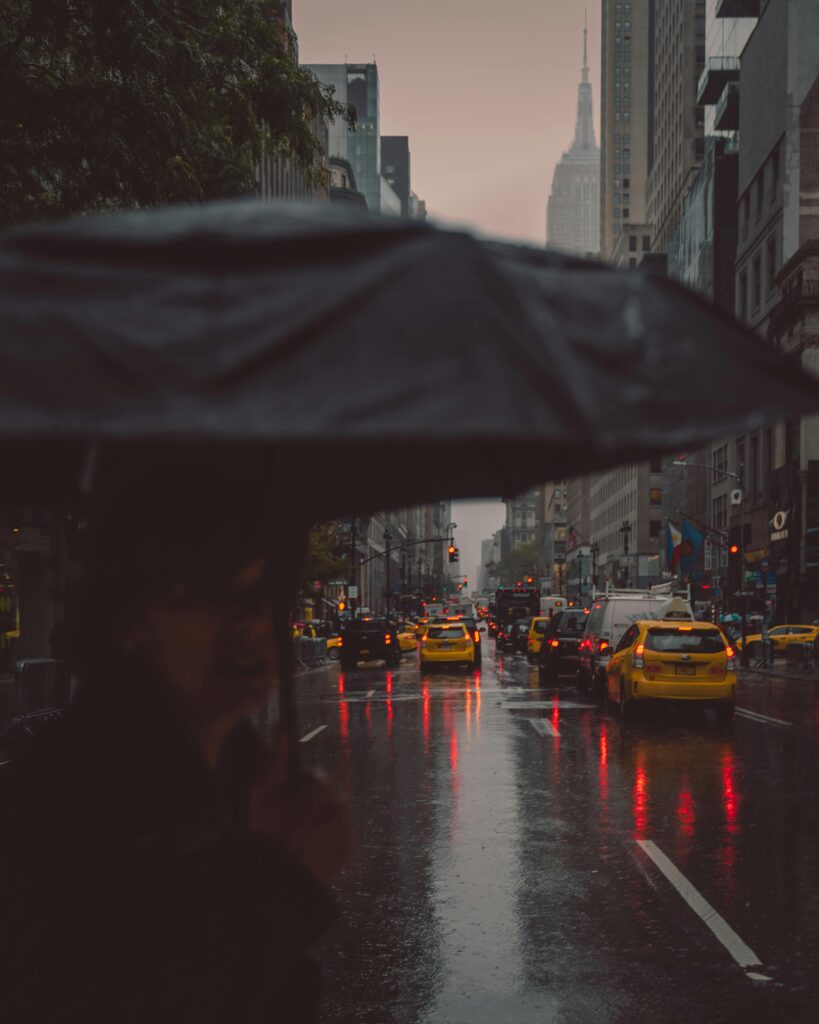New York City taxis driving at sunset on a Manhattan avenue, illustrating visibility challenges after the clock change