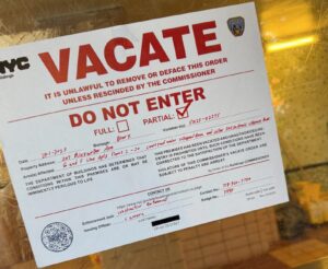NYC Department of Buildings vacate order posted at Mitchel Houses after boiler-chimney explosion in the Bronx